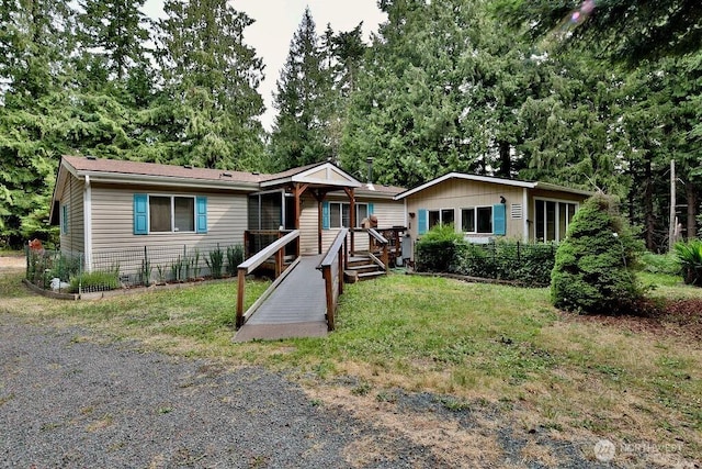 140 Fleming Dr, Sequim, WA 98382 - single story home featuring a front lawn, covered porch, and view of wooded area