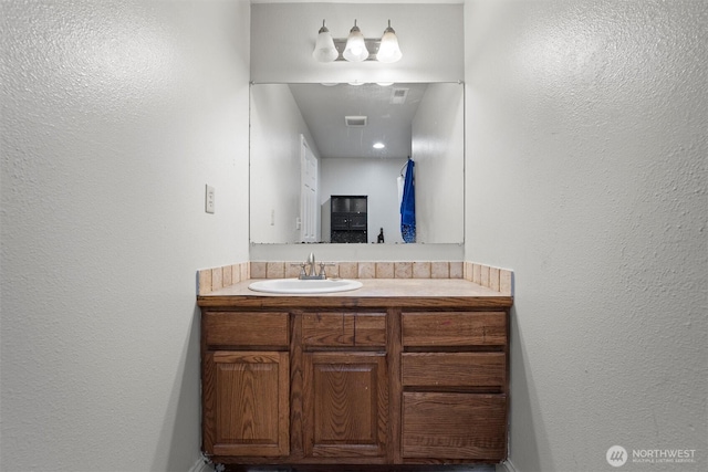 620 N Larkspur, Othello, WA 99344 - bathroom featuring vanity and a textured wall
