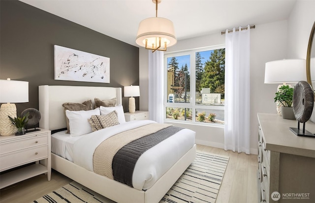 18226 68th Ave NE Unit 502, Kenmore, WA 98028 - bedroom featuring light wood-style flooring and a chandelier