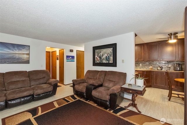 3400 Narrows View Ln NE Unit 204, Bremerton, WA 98310 - living area featuring light wood-style flooring, a textured ceiling, and a ceiling fan