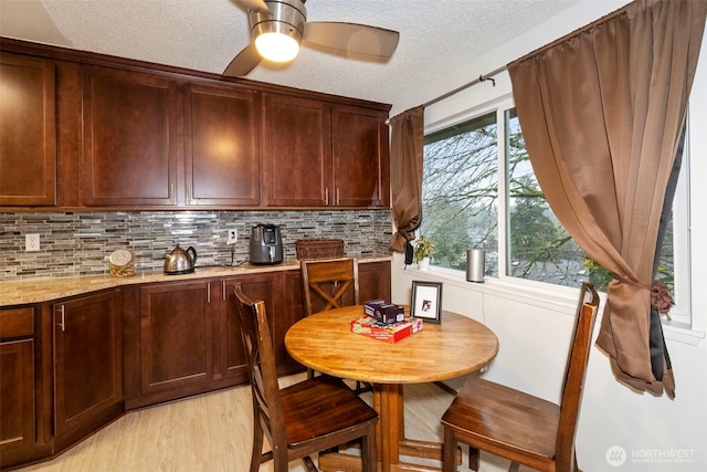 3400 Narrows View Ln NE Unit 204, Bremerton, WA 98310 - dining room featuring a textured ceiling, light wood-style flooring, and ceiling fan