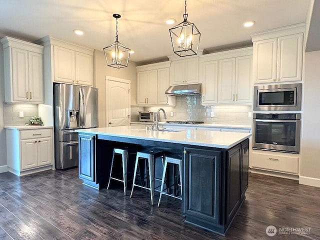 885 N Squire Dr, Ridgefield, WA 98642 - kitchen featuring stainless steel appliances, white cabinetry, under cabinet range hood, and recessed lighting