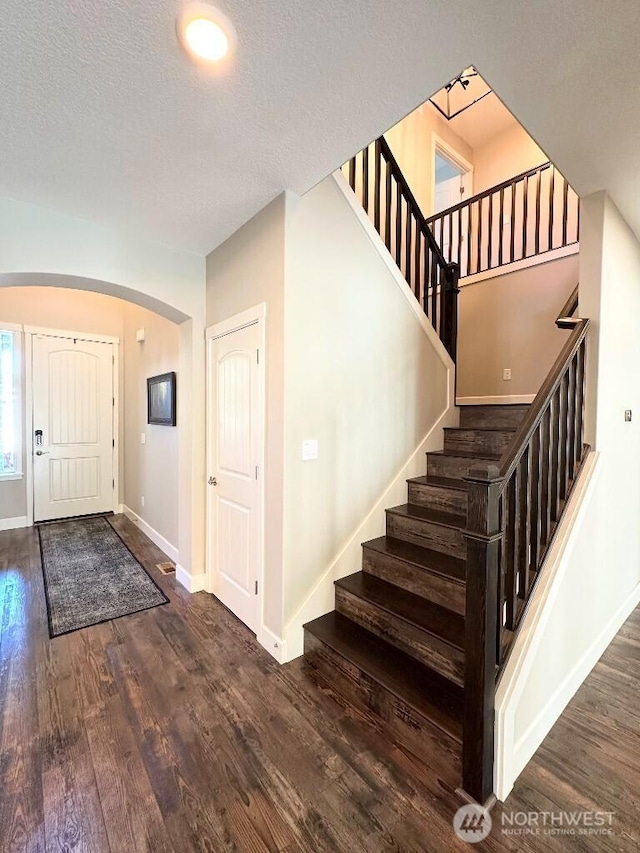885 N Squire Dr, Ridgefield, WA 98642 - foyer featuring arched walkways, stairway, wood finished floors, and a textured ceiling