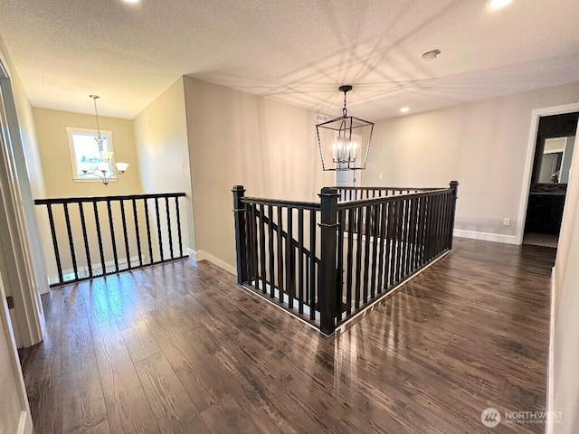 885 N Squire Dr, Ridgefield, WA 98642 - hall with a chandelier, dark wood-style flooring, an upstairs landing, recessed lighting, and a textured ceiling