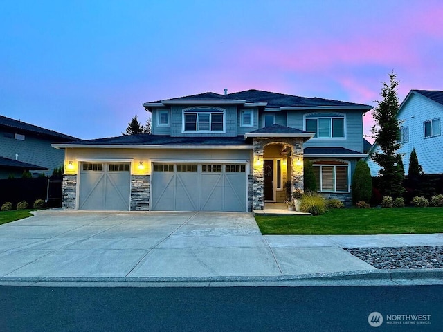 885 N Squire Dr, Ridgefield, WA 98642 - view of front facade featuring stone siding, a front lawn, driveway, and a garage