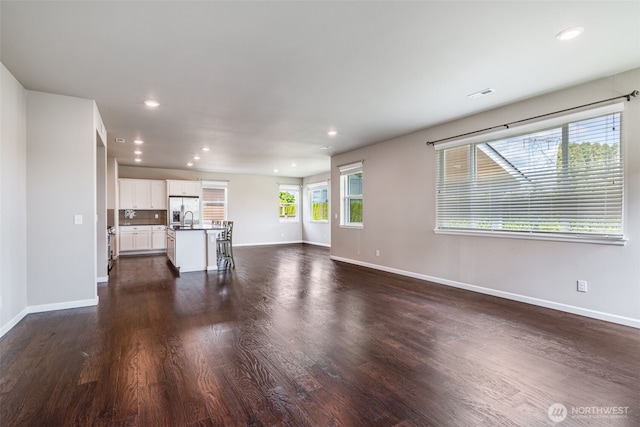 7336 Ashdown Ln SE, Olympia, WA 98513 - unfurnished living room with dark wood-type flooring and recessed lighting