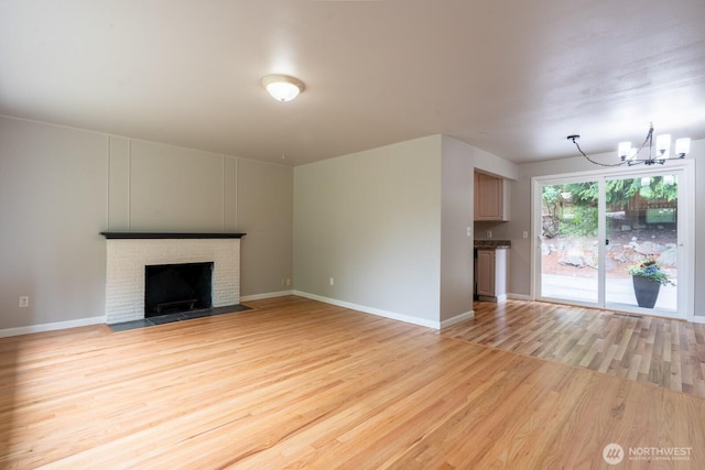 4638 148th Ave SE, Bellevue, WA 98006 - unfurnished living room featuring a chandelier, light wood-style flooring, and a fireplace