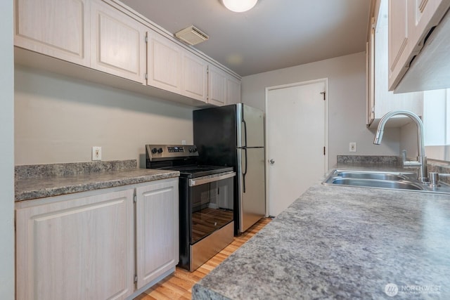 4638 148th Ave SE, Bellevue, WA 98006 - kitchen featuring electric stove, light wood-style floors, freestanding refrigerator, light countertops, and white cabinetry