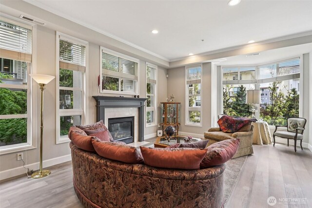 520 6th Ave Unit 2001, Kirkland, WA 98033 - living area with ornamental molding, wood finished floors, a fireplace, and recessed lighting