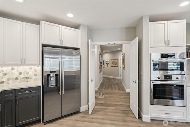 520 6th Ave Unit 2001, Kirkland, WA 98033 - kitchen featuring appliances with stainless steel finishes, white cabinetry, light wood-style floors, light countertops, and recessed lighting