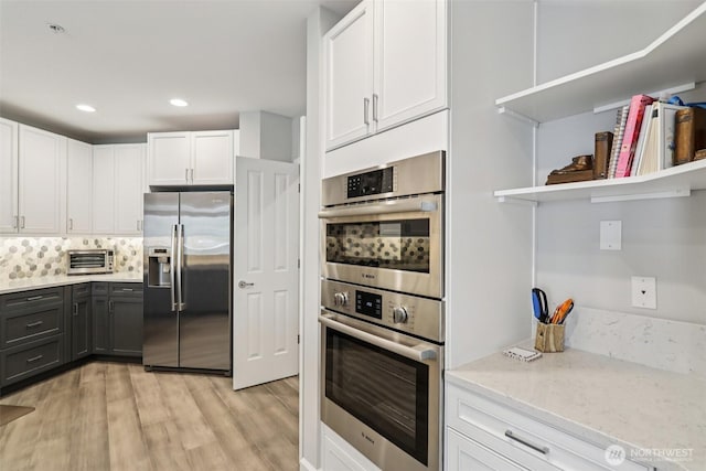 520 6th Ave Unit 2001, Kirkland, WA 98033 - kitchen with appliances with stainless steel finishes, open shelves, light wood-style flooring, white cabinetry, and recessed lighting