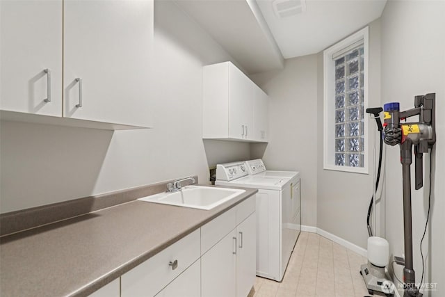 520 6th Ave Unit 2001, Kirkland, WA 98033 - laundry area with cabinet space, washing machine and clothes dryer, and light tile patterned floors