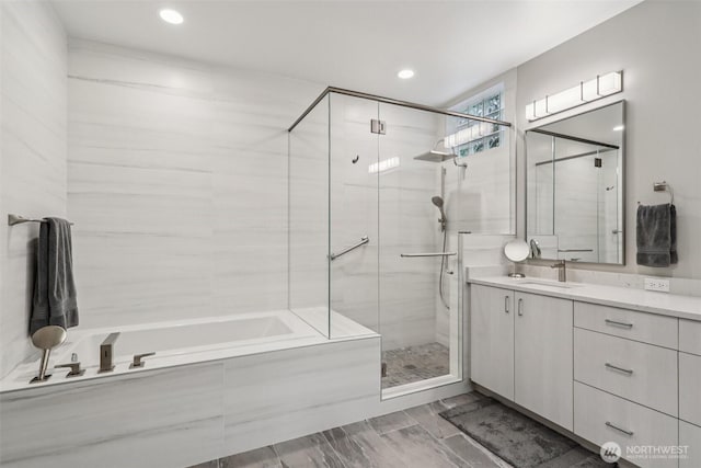 520 6th Ave Unit 2001, Kirkland, WA 98033 - full bathroom with a stall shower, a garden tub, vanity, and recessed lighting