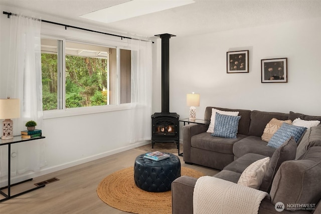 18304 Mclean Rd SW, Vashon, WA 98070 - living room with wood finished floors and a wood stove