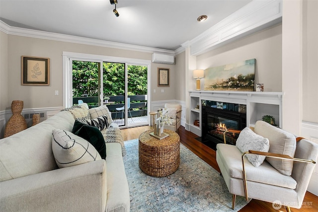 4314 Linden Ave N, Seattle, WA 98103 - living room featuring an AC wall unit, crown molding, a fireplace with flush hearth, wood finished floors, and wainscoting