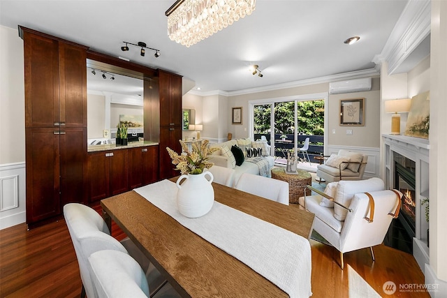 4314 Linden Ave N, Seattle, WA 98103 - dining room with crown molding, dark wood-type flooring, a wainscoted wall, a decorative wall, and a wall mounted air conditioner