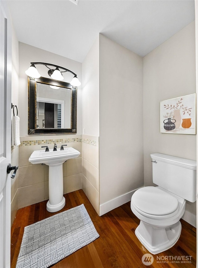 4314 Linden Ave N, Seattle, WA 98103 - bathroom featuring tile walls, wood finished floors, and wainscoting
