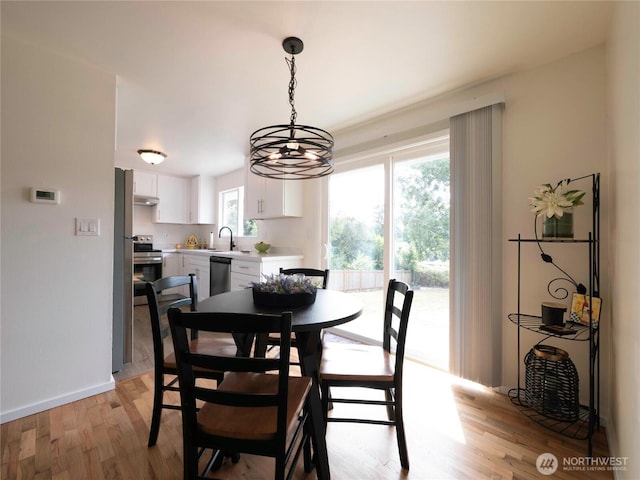 18111 46th Ave S, Seatac, WA 98188 - dining space with light wood-style floors and a chandelier