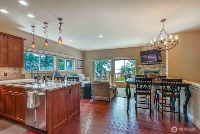 211 Geer Ln, Orcas Island, WA 98245 - kitchen with dishwasher, open floor plan, light stone countertops, a chandelier, and recessed lighting