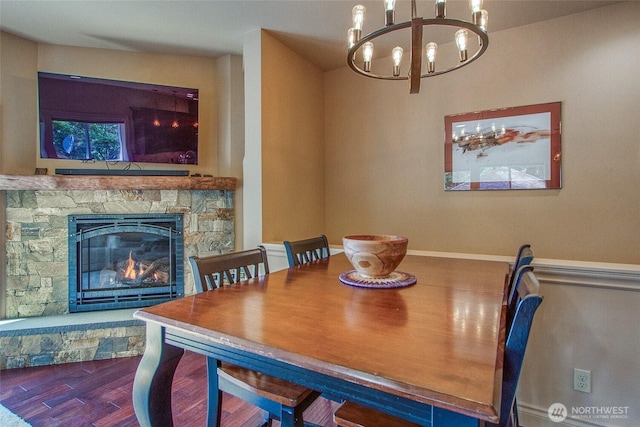 211 Geer Ln, Orcas Island, WA 98245 - dining room with a chandelier, wood finished floors, and a stone fireplace