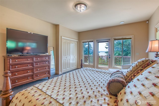 211 Geer Ln, Orcas Island, WA 98245 - bedroom with access to exterior, dark colored carpet, and a closet