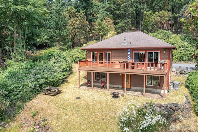 211 Geer Ln, Orcas Island, WA 98245 - back of house with a patio area, a deck, roof with shingles, a lawn, and a view of trees
