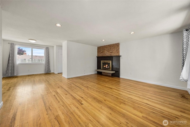 2530 SW 325th Pl, Federal Way, WA 98003 - unfurnished living room featuring light wood-style flooring, recessed lighting, and a brick fireplace