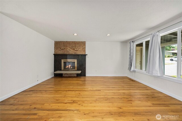 2530 SW 325th Pl, Federal Way, WA 98003 - unfurnished living room with light wood-style flooring, a fireplace, and recessed lighting