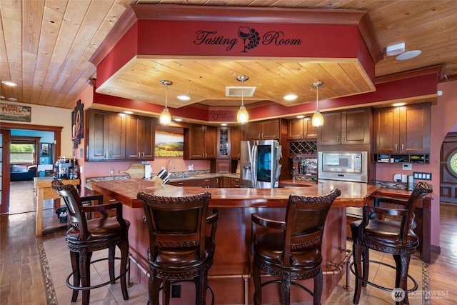 3151 Velvet Ln, Custer, WA 98240 - kitchen with appliances with stainless steel finishes, wood ceiling, wood counters, glass insert cabinets, and a breakfast bar