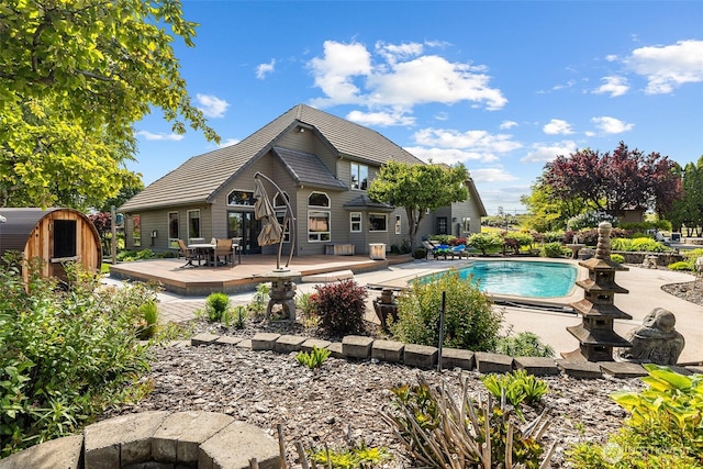 78718 Echols Rd, Hermiston, OR 97838 - outdoor pool featuring a wooden deck, a storage unit, and outdoor dining space