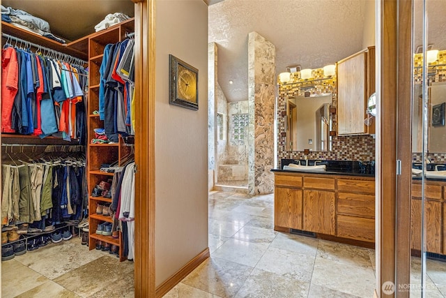 78718 Echols Rd, Hermiston, OR 97838 - bathroom with vanity, a spacious closet, and tasteful backsplash