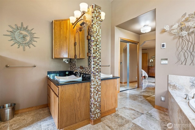 78718 Echols Rd, Hermiston, OR 97838 - full bath featuring vanity, tiled bath, tasteful backsplash, and ensuite bathroom