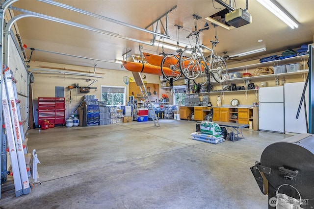 78718 Echols Rd, Hermiston, OR 97838 - garage with a garage door opener, freestanding refrigerator, and a workshop area