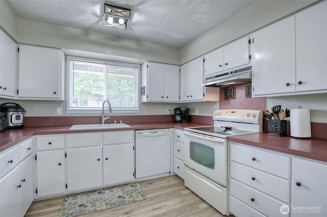 218 Holly Ln, Cosmopolis, WA 98537 - kitchen featuring white appliances, under cabinet range hood, white cabinets, light wood-type flooring, and dark countertops