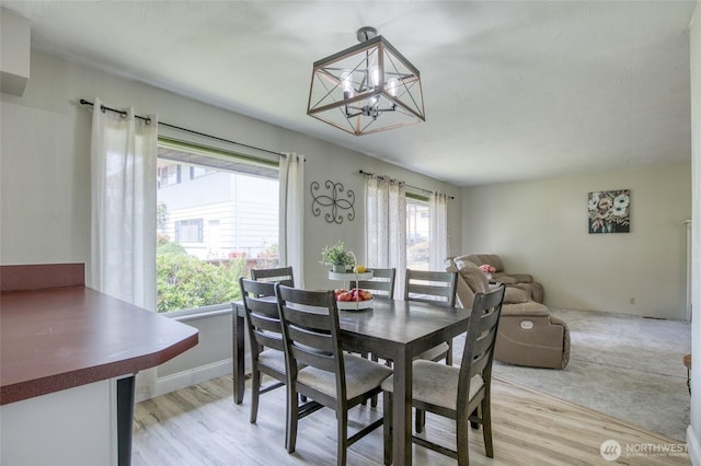 218 Holly Ln, Cosmopolis, WA 98537 - dining room featuring light wood finished floors and a chandelier