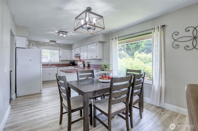 218 Holly Ln, Cosmopolis, WA 98537 - dining area featuring a chandelier and light wood-style floors