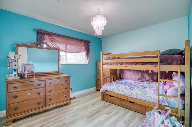 218 Holly Ln, Cosmopolis, WA 98537 - bedroom featuring wood finished floors and a chandelier