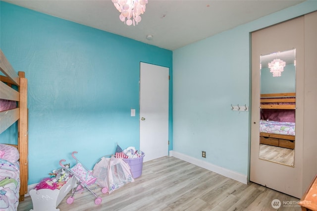 218 Holly Ln, Cosmopolis, WA 98537 - bedroom with wood finished floors and a chandelier