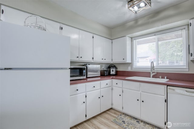218 Holly Ln, Cosmopolis, WA 98537 - kitchen featuring white appliances, white cabinetry, light wood-type flooring, and dark countertops