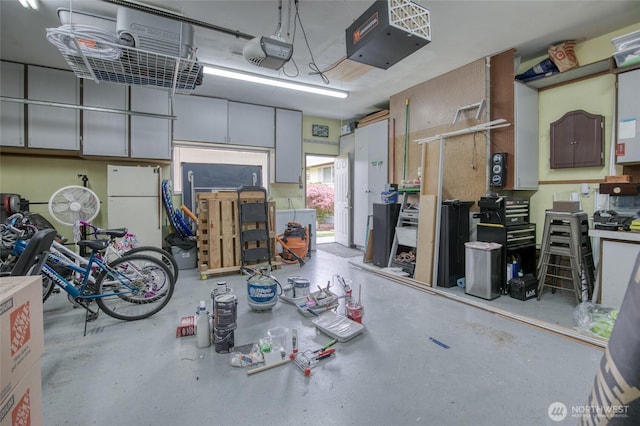 218 Holly Ln, Cosmopolis, WA 98537 - garage with freestanding refrigerator, a garage door opener, and a heating unit