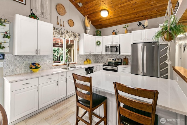 19322 Old Burn Rd, Arlington, WA 98223 - kitchen with stainless steel appliances, wooden ceiling, backsplash, light countertops, and white cabinets