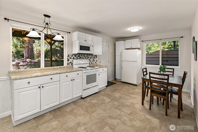 19322 Old Burn Rd, Arlington, WA 98223 - kitchen with white appliances, a chandelier, white cabinetry, decorative light fixtures, and tasteful backsplash