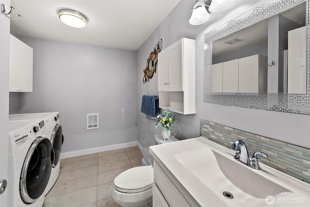 19322 Old Burn Rd, Arlington, WA 98223 - bathroom featuring separate washer and dryer, tasteful backsplash, and vanity