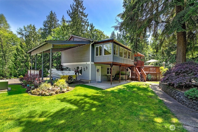 19322 Old Burn Rd, Arlington, WA 98223 - back of house featuring a deck, stairs, a lawn, and a carport
