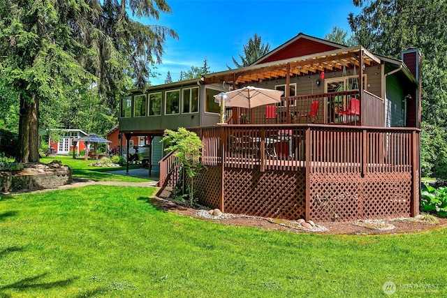 19322 Old Burn Rd, Arlington, WA 98223 - back of property featuring a wooden deck, a yard, a chimney, and a sunroom