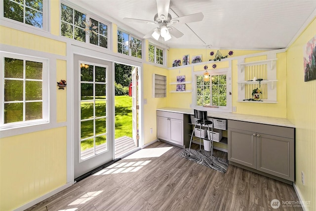 19322 Old Burn Rd, Arlington, WA 98223 - home office featuring vaulted ceiling, a ceiling fan, built in desk, plenty of natural light, and wood finished floors