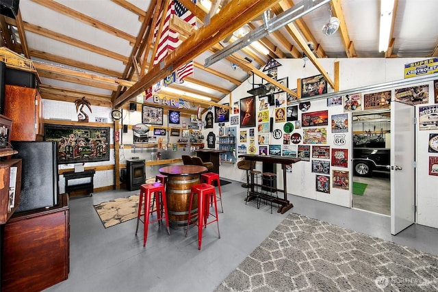 19322 Old Burn Rd, Arlington, WA 98223 - dining area with lofted ceiling, finished concrete flooring, and a wood stove