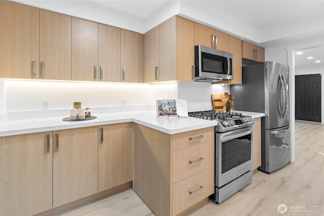 12023 35th Ave NE, Seattle, WA 98125 - kitchen featuring stainless steel appliances, light brown cabinets, light wood-style floors, light countertops, and recessed lighting
