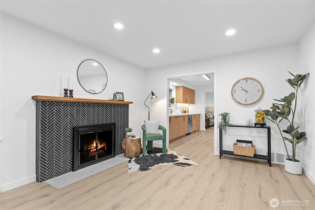 12023 35th Ave NE, Seattle, WA 98125 - living room featuring light wood-style floors, a tile fireplace, and recessed lighting