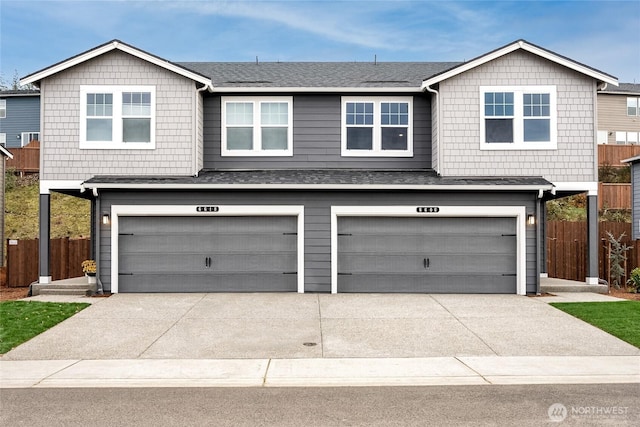 7404B 281st St NW Unit 59, Stanwood, WA 98292 - view of front facade featuring an attached garage, concrete driveway, and a shingled roof